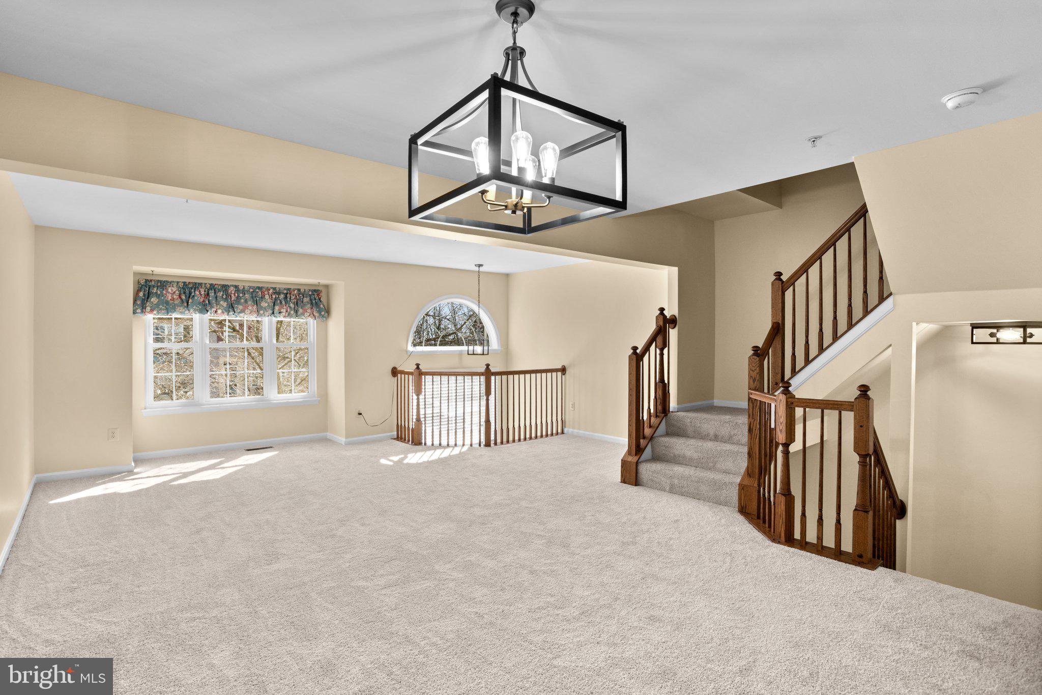 6342 Arbor Way Elkridge, MD 21075 - Photo 10 of 30 a view of empty room with stairs and windows