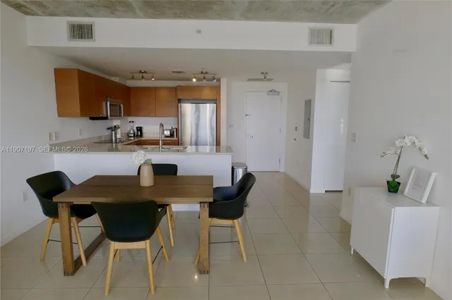 a view of a kitchen with dining table and chairs