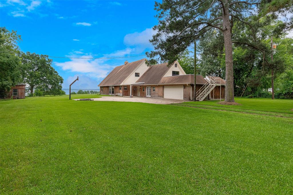 10307 Pirogue Road Oil City, LA 71061 - Photo 3 of 36 a view of a house with a big yard and large trees