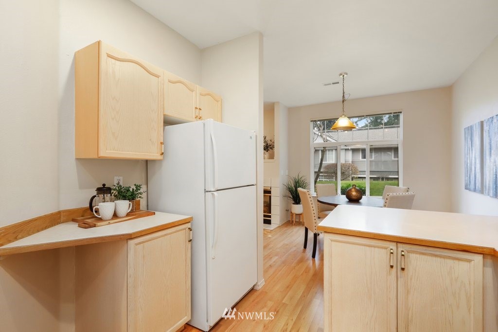 22611 4th Avenue West, Unit 103 Bothell, WA 98021 - Photo 8 of 25 a kitchen with refrigerator a sink and cabinets