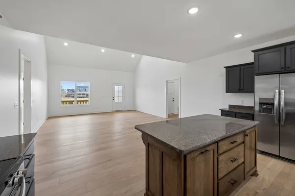 a kitchen with a table chairs and a refrigerator