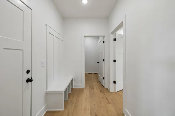 a view of a hallway with wooden floor