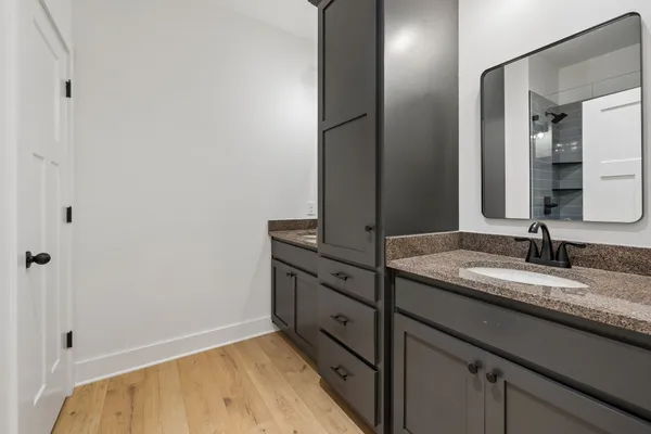 a bathroom with a granite countertop sink and a mirror