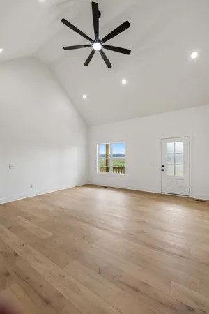 an empty room with a empty space and a ceiling fan