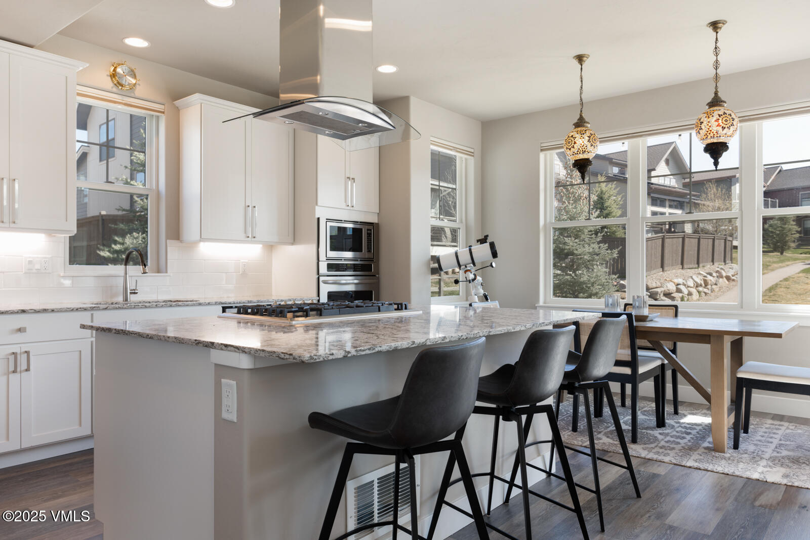 25 Soleil Circle Eagle, CO 81631 - Photo 16 of 48 a kitchen with center island table and chairs in it