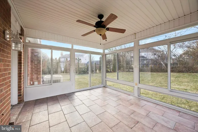 a view of an empty room and window ceiling fan