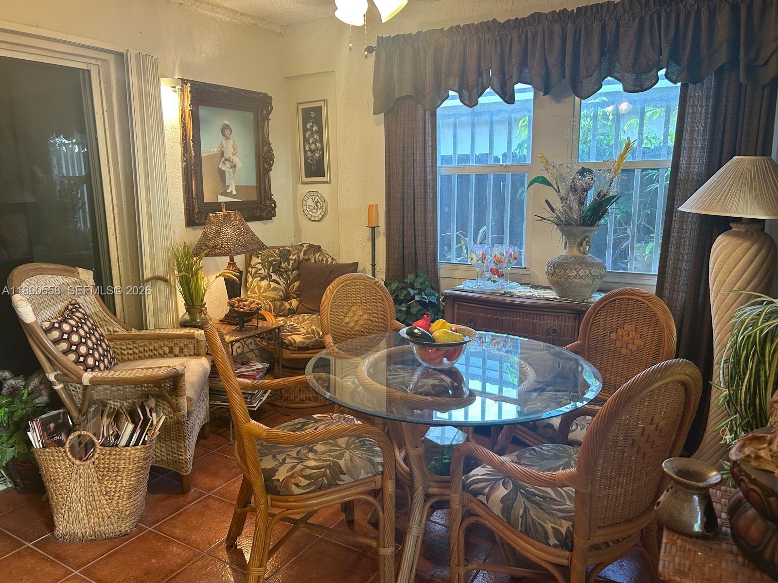 7891 Southwest 162nd Court Miami, FL 33193 - Photo 11 of 19 a dining room with furniture a chandelier and wooden floor