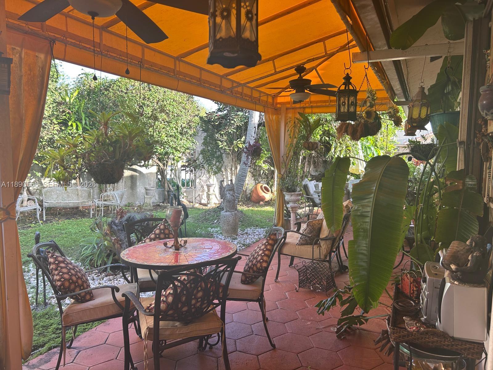 7891 Southwest 162nd Court Miami, FL 33193 - Photo 15 of 19 a table and chairs in a patio