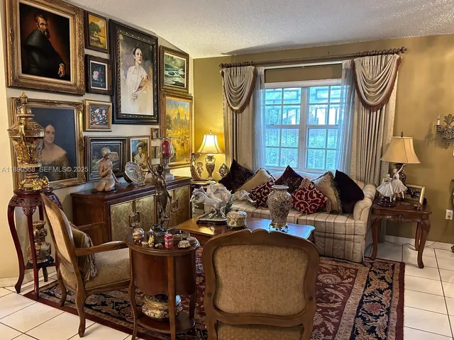 a living room with furniture a window and a chandelier