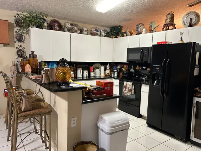 a kitchen with stainless steel appliances a refrigerator and a stove