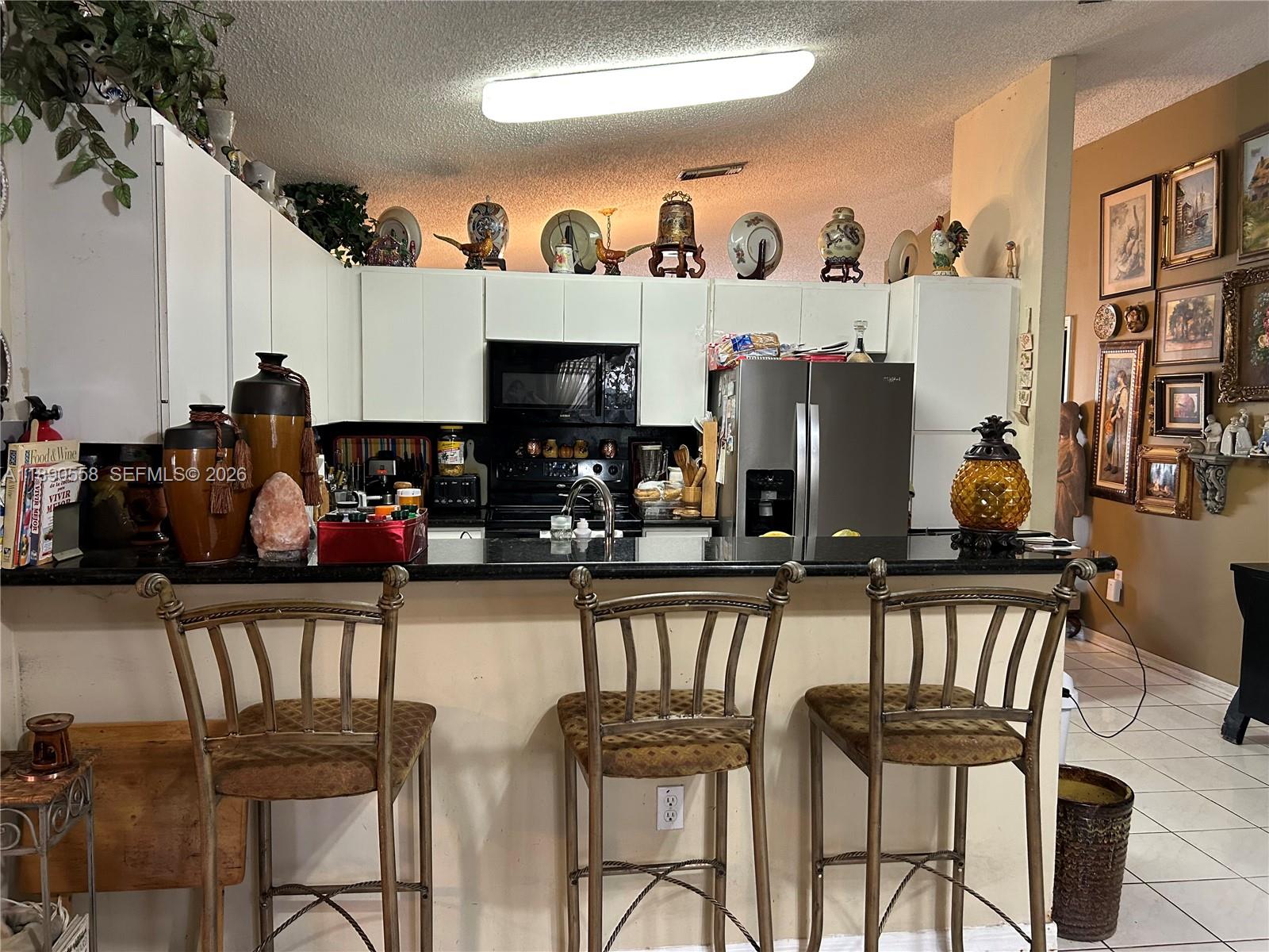 7891 Southwest 162nd Court Miami, FL 33193 - Photo 9 of 19 a view of a dining room with furniture and a kitchen