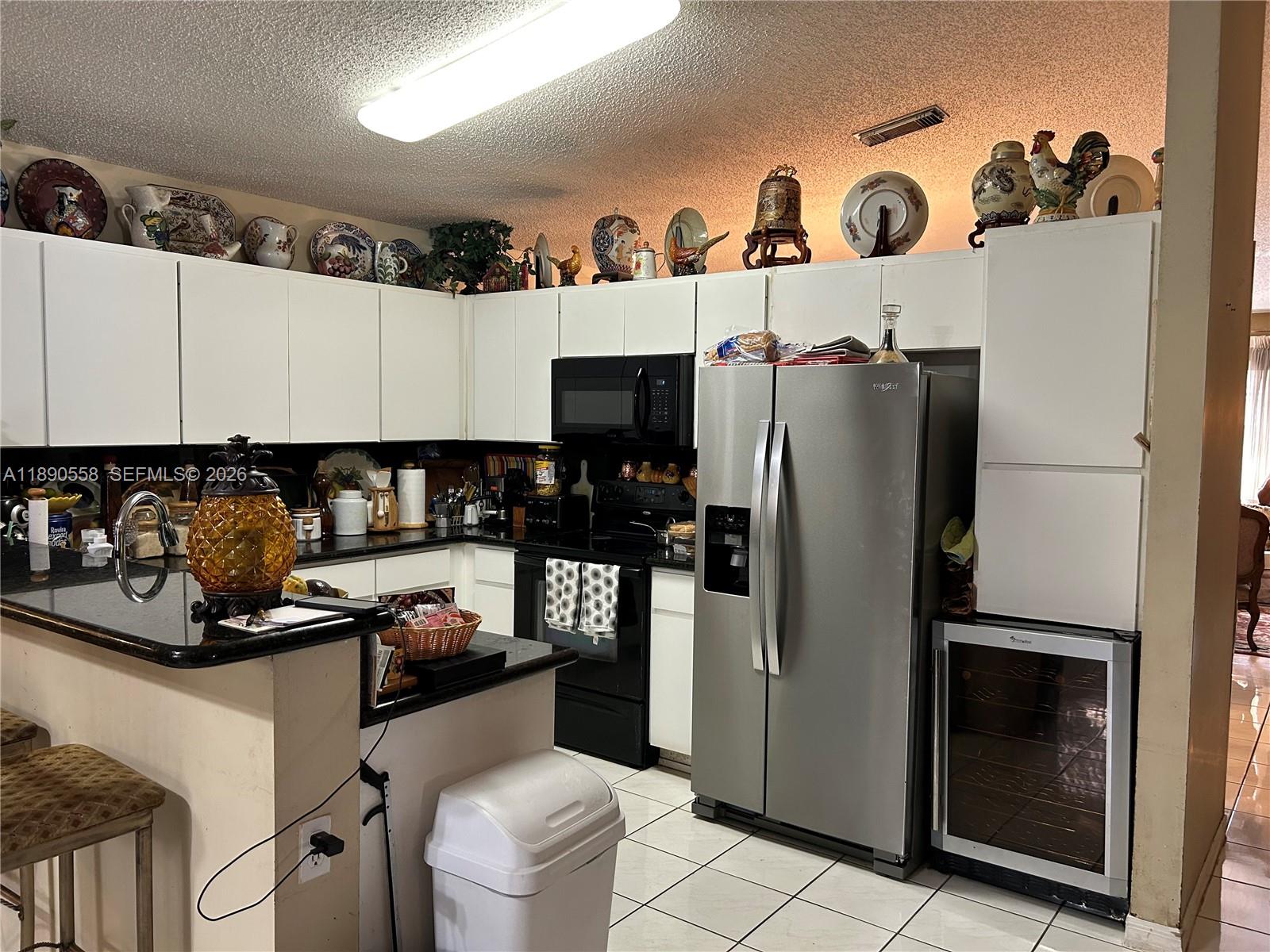 7891 Southwest 162nd Court Miami, FL 33193 - Photo 10 of 19 a kitchen with stainless steel appliances a refrigerator and a stove