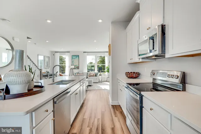 a kitchen with cabinets wooden floor and a sink