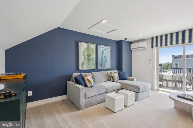 a living room with furniture and a floor to ceiling window