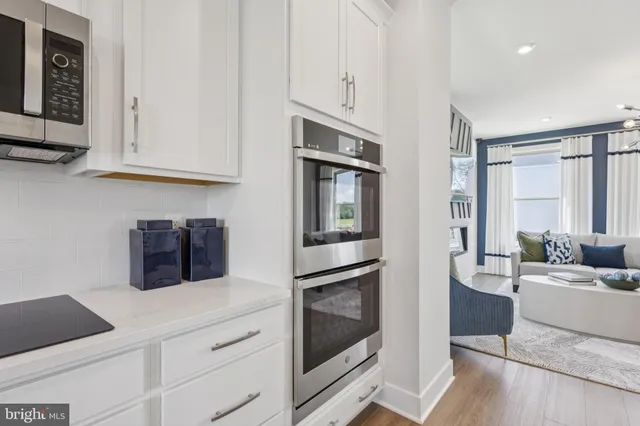 a kitchen with stainless steel appliances granite countertop a refrigerator and cabinets