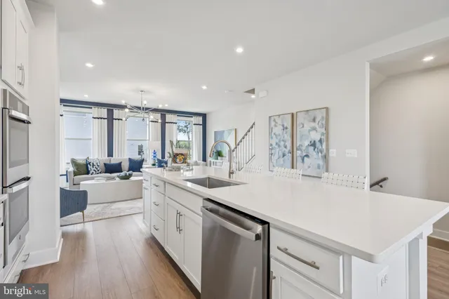 a large white kitchen with a large window