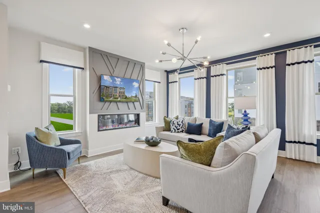 a living room with furniture a flat screen tv and a large window