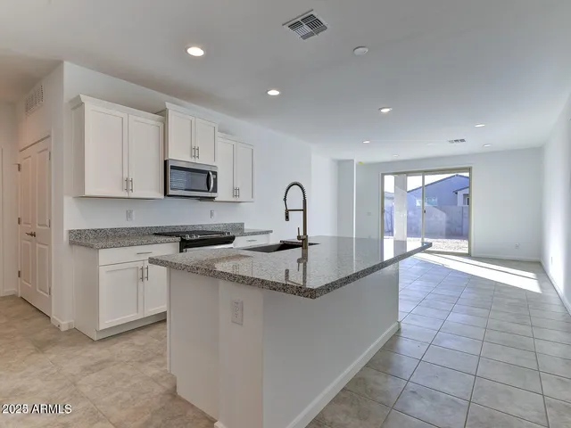 a kitchen with a sink stove and cabinets