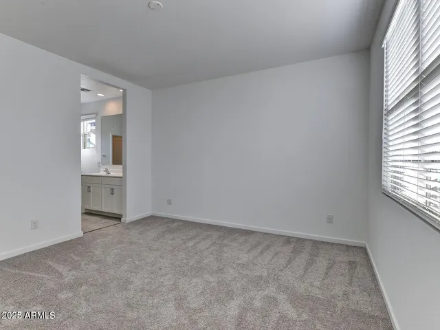 an empty room with windows and entrance