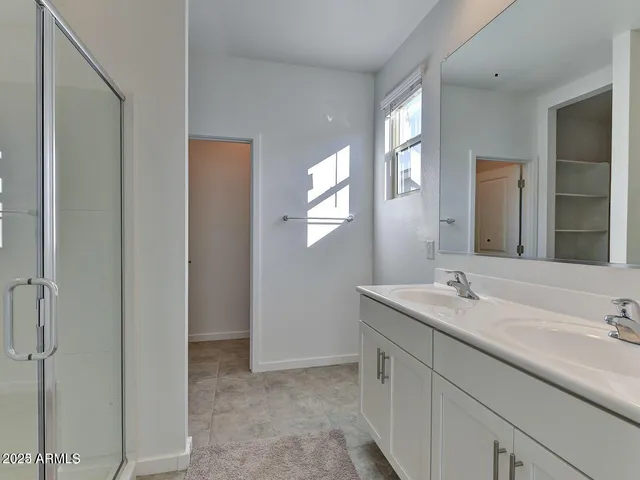 a bathroom with a double vanity sink and a mirror