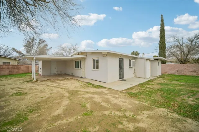 a view of a house with a backyard and a yard