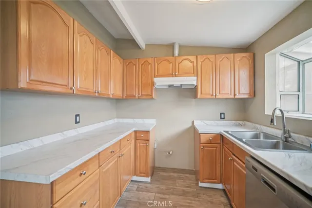 a kitchen with stainless steel appliances granite countertop a sink and a white cabinets