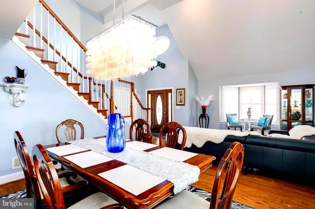 a kitchen with a table chairs sink and cabinets