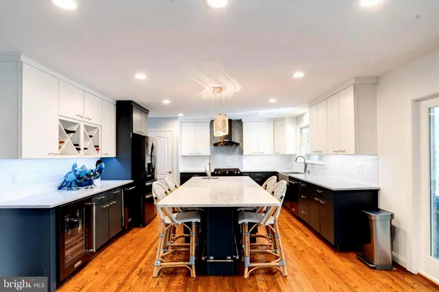 a kitchen with stainless steel appliances a refrigerator and a stove top oven