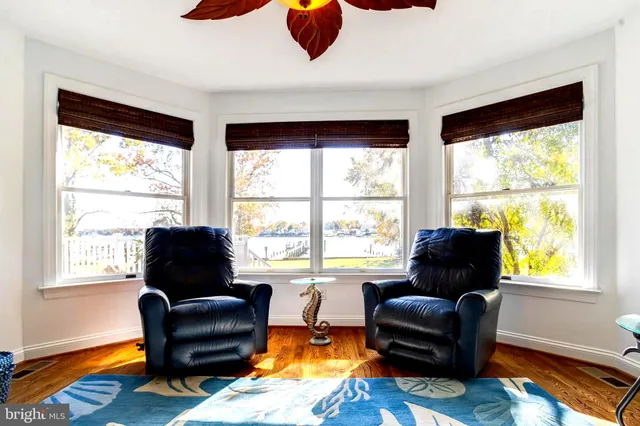 a bedroom with a bed and large windows