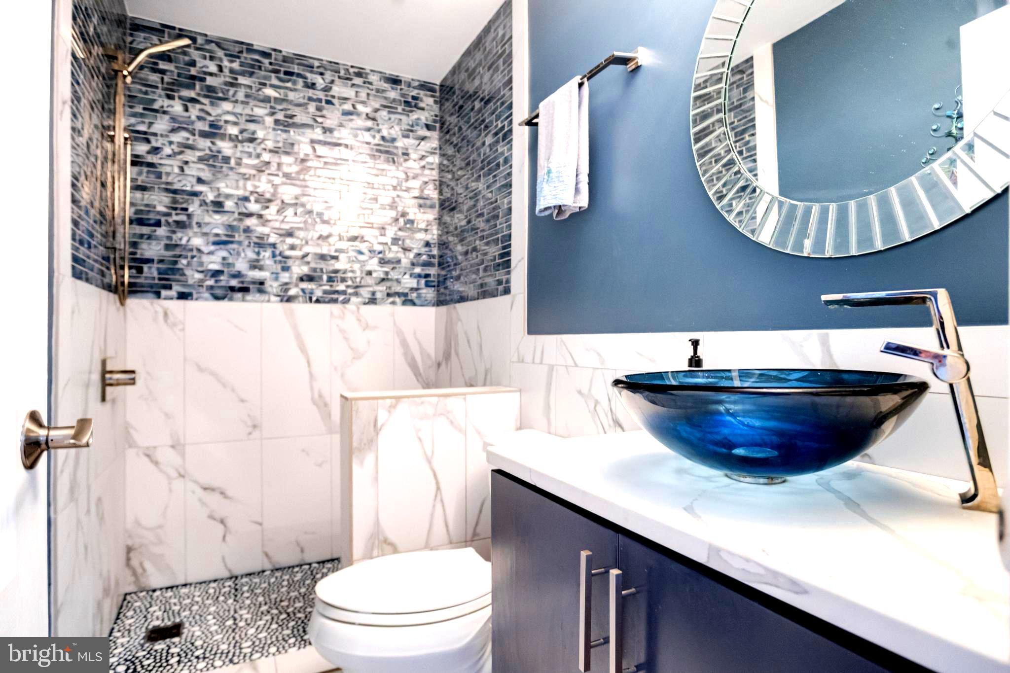1432 Shore Road Baltimore, MD 21220 - Photo 20 of 63 a bathroom with a sink a toilet and a mirror