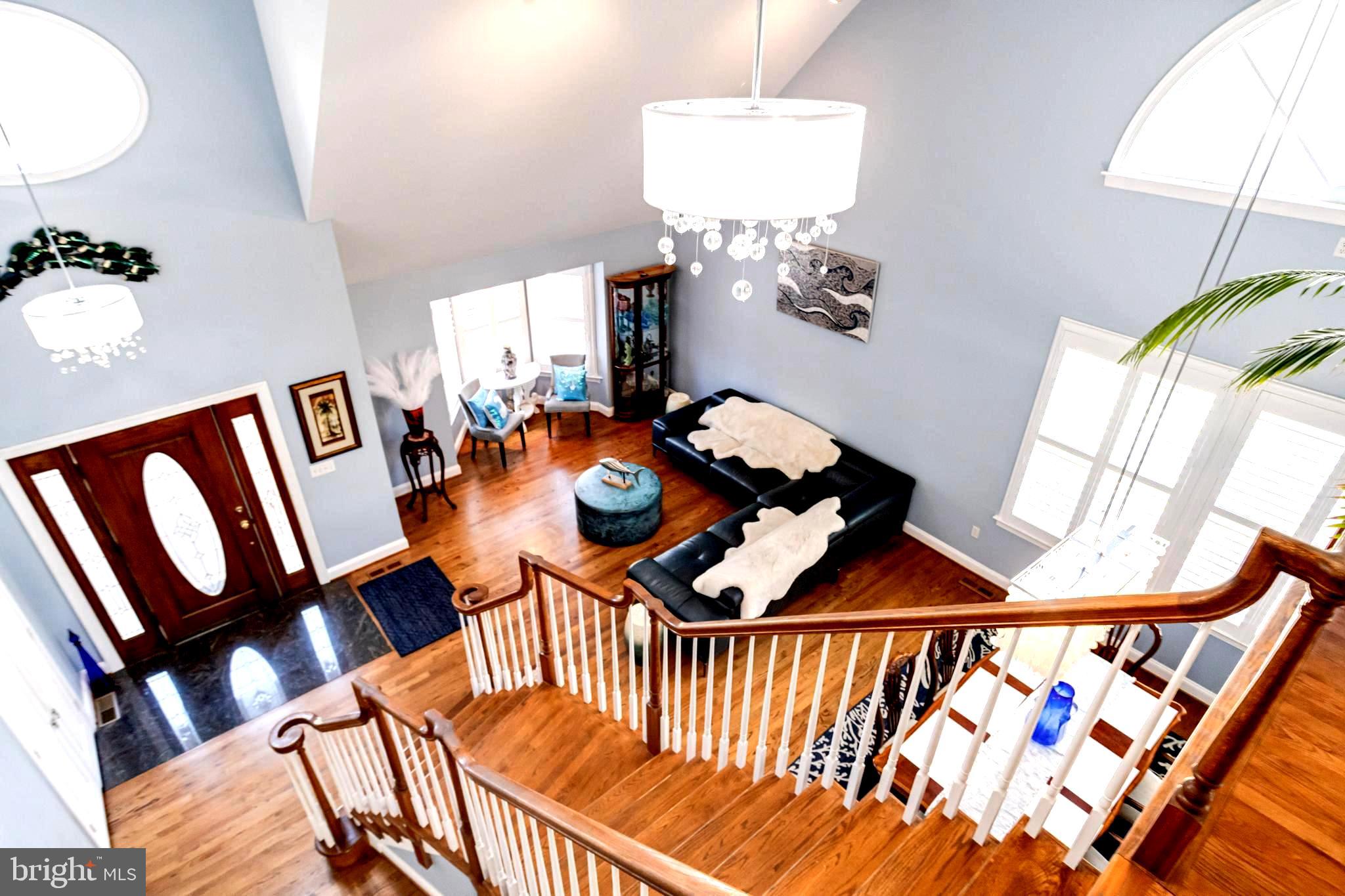 1432 Shore Road Baltimore, MD 21220 - Photo 24 of 63 a balcony and dining room with furniture wooden floor and a chandelier