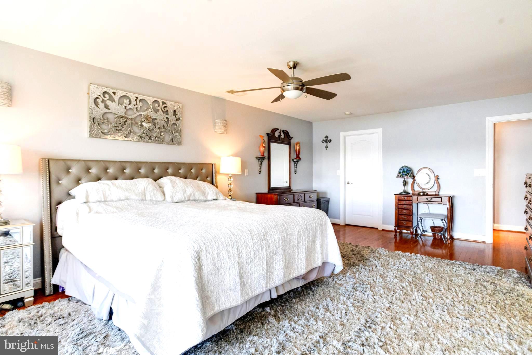 1432 Shore Road Baltimore, MD 21220 - Photo 28 of 63 a bedroom with a bed and wooden floor
