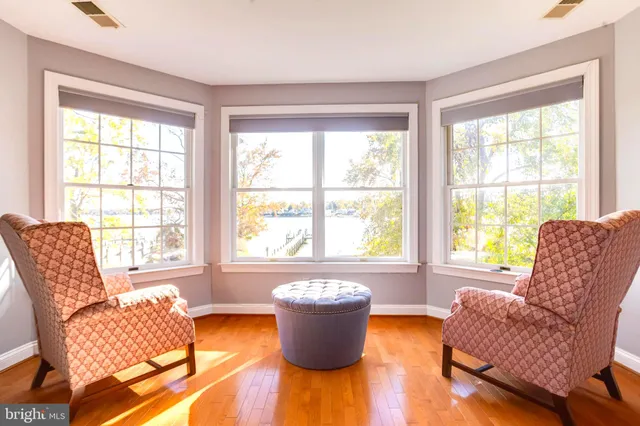 a living room with furniture and a floor to ceiling window