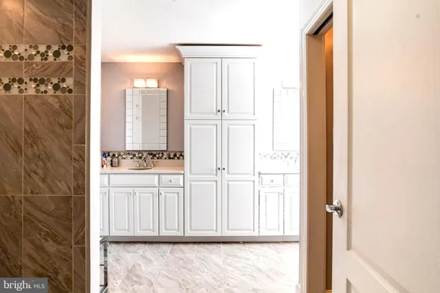 a view of a living room with a floor to ceiling window and wooden floor