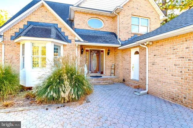 a living room with furniture a rug and a large window