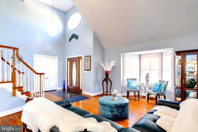 a dining room with furniture and wooden floor