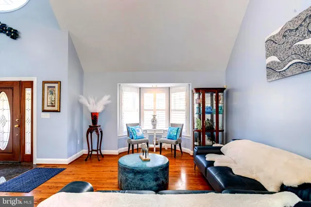 a view of a livingroom with furniture staircase and floor to ceiling windows