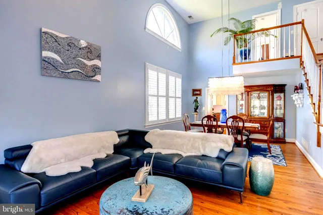 a dining room with furniture and wooden floor