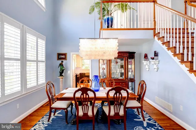 a kitchen with stainless steel appliances a dining table chairs and granite counter tops