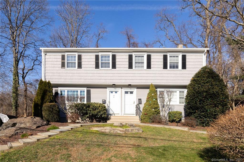 96 Rodgers Road, Unit 96 Fairfield, CT 06824 - Photo 1 of 1 a house that has a tree in front of it