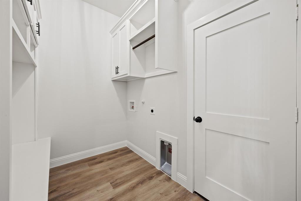 104 Maverick Trail Valley View, TX 76272 - Photo 25 of 30 a view of a hallway with wooden floor and staircase
