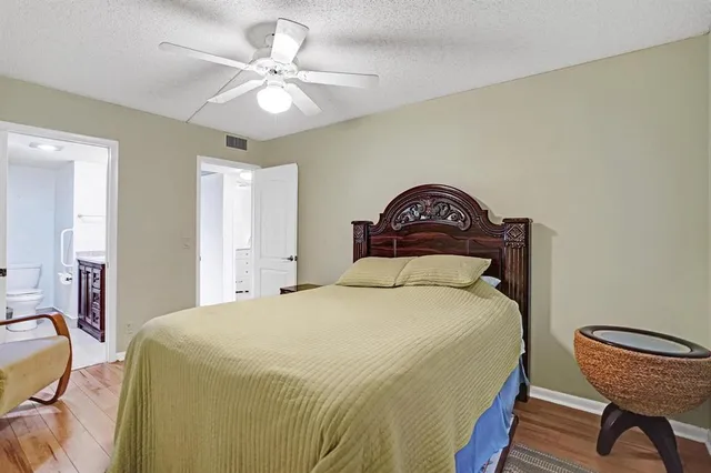 a bedroom with a bed and a chair