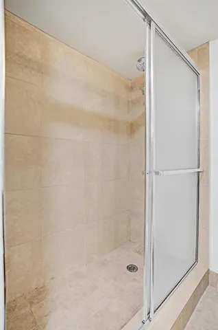 a bathroom with a glass shower door