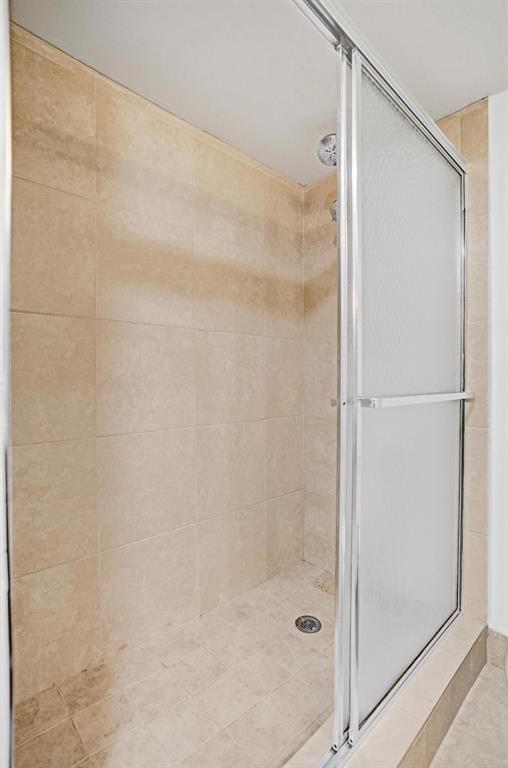 1005 Lincoln A, Unit 1005 Boca Raton, FL 33434 - Photo 13 of 33 a bathroom with a glass shower door