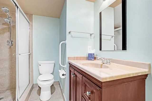 a bathroom with a sink a toilet and a mirror
