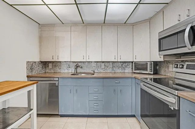 a kitchen with stainless steel appliances granite countertop a sink and stove top oven