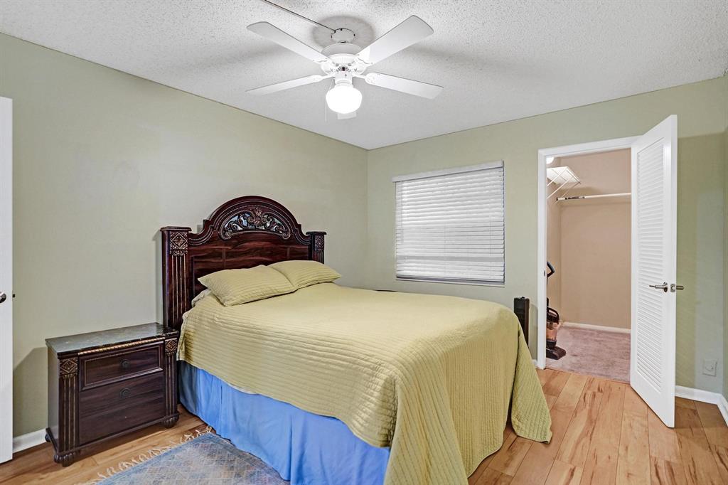 1005 Lincoln A, Unit 1005 Boca Raton, FL 33434 - Photo 10 of 33 a bedroom with a bed and a chandelier