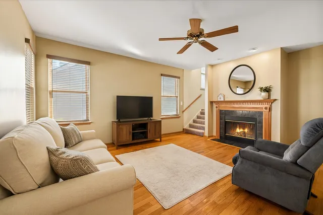 a living room with furniture a fireplace and a flat screen tv