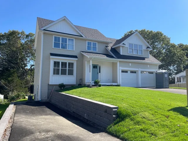 a front view of house with yard and green space