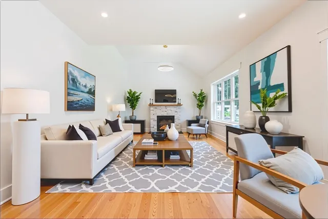a living room with furniture flat screen tv and a fireplace